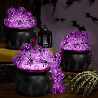 Indoor Halloween DIY Bubbling Witch Cauldron. Consists of 1 witch cauldron, cotton filling, 40 clear balls, and a string of twinkling lights, glue, and 10 simulated spiders.