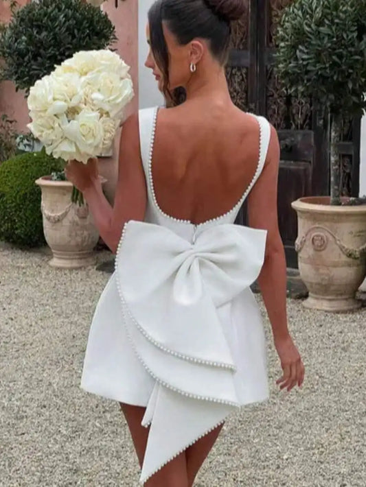 A-Line Mini Dress with Pearl-Trimmed Backless Design and Oversized Bow Also available in Pink and Black