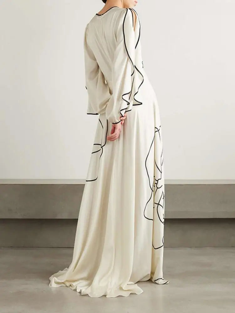 Boho Floor Length Evening Dress, Round Neck, Open Ruffled Sleeves trimmed in Black, Dress has an artistic Black on White Floral Design